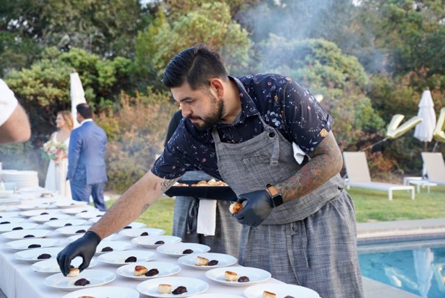 Daniel Cortez preparing plates for an event
